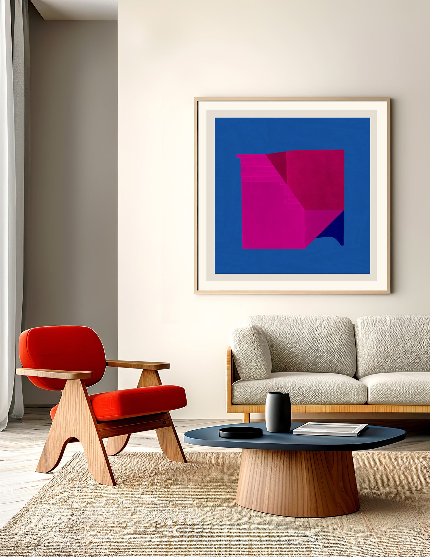 A modern living room with a beige sofa, red accent chair, round black coffee table, and "Abstract composition 495," a limited edition artwork with magenta geometric shapes on blue printed on museum-quality paper.